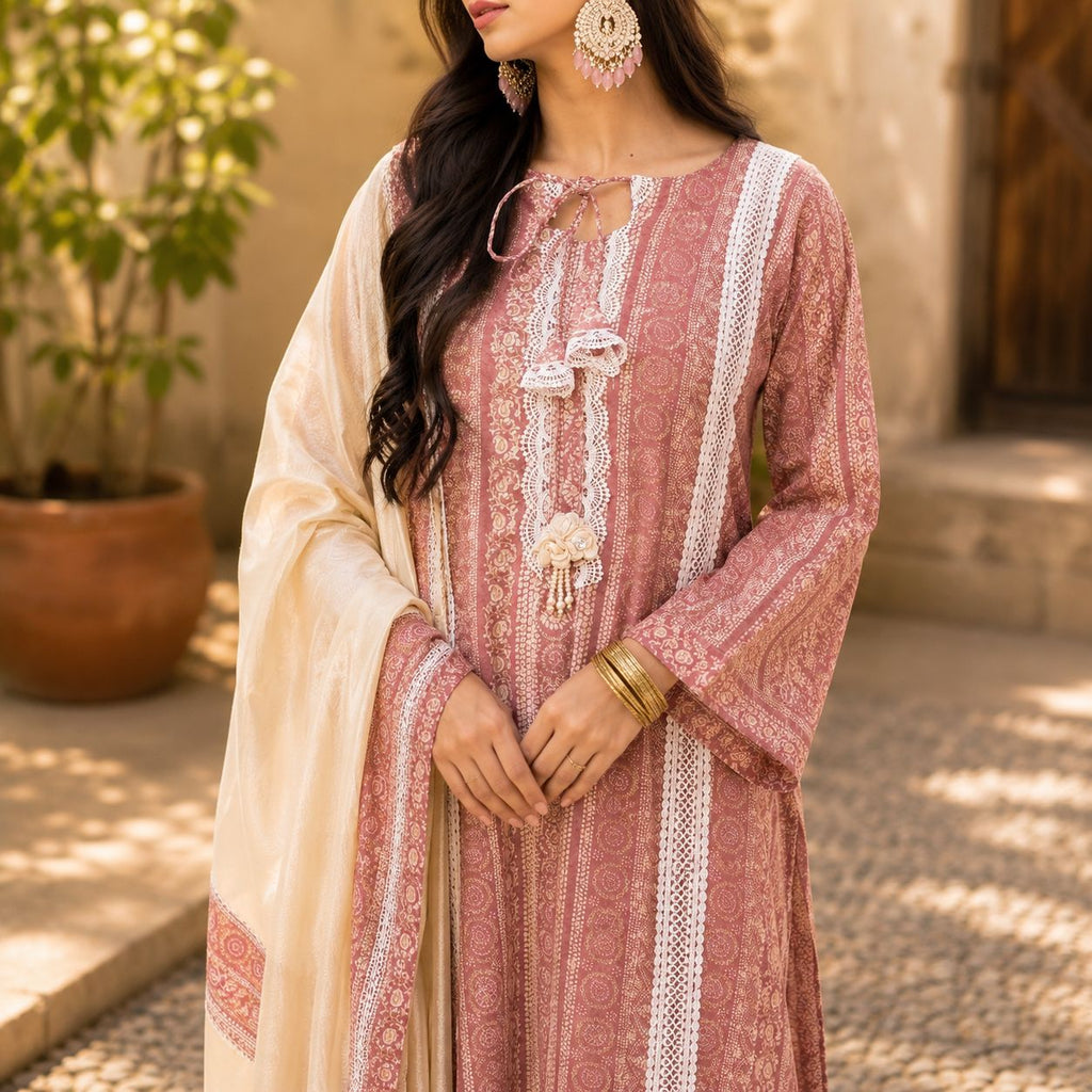 Woman wearing a patterned dress with a beige shawl outdoors.
