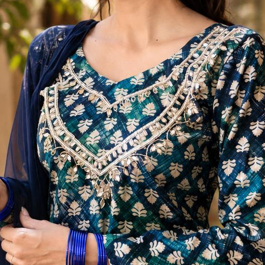 Close-up of a blue and white patterned blouse with lace work.